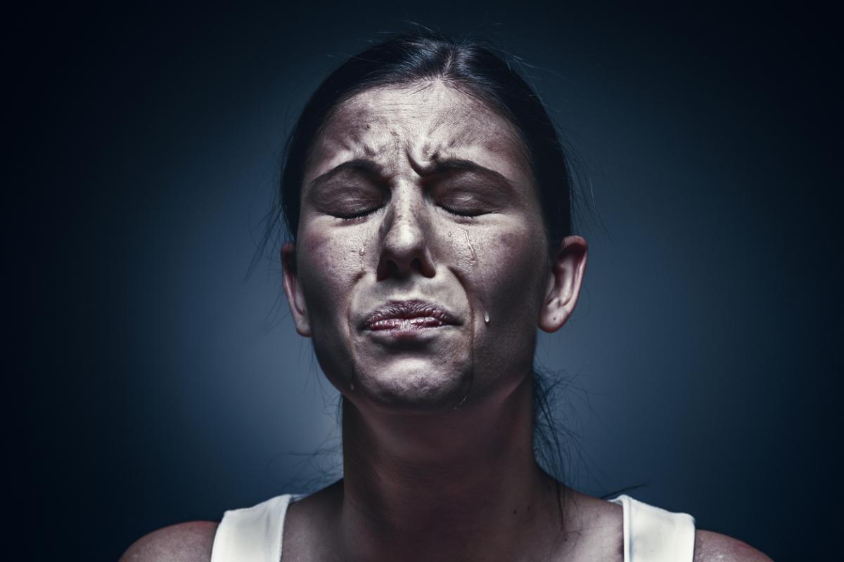 Close up portrait of a crying woman with bruised skin and black eyes - Vero